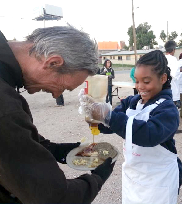 volunteer serving breakfast